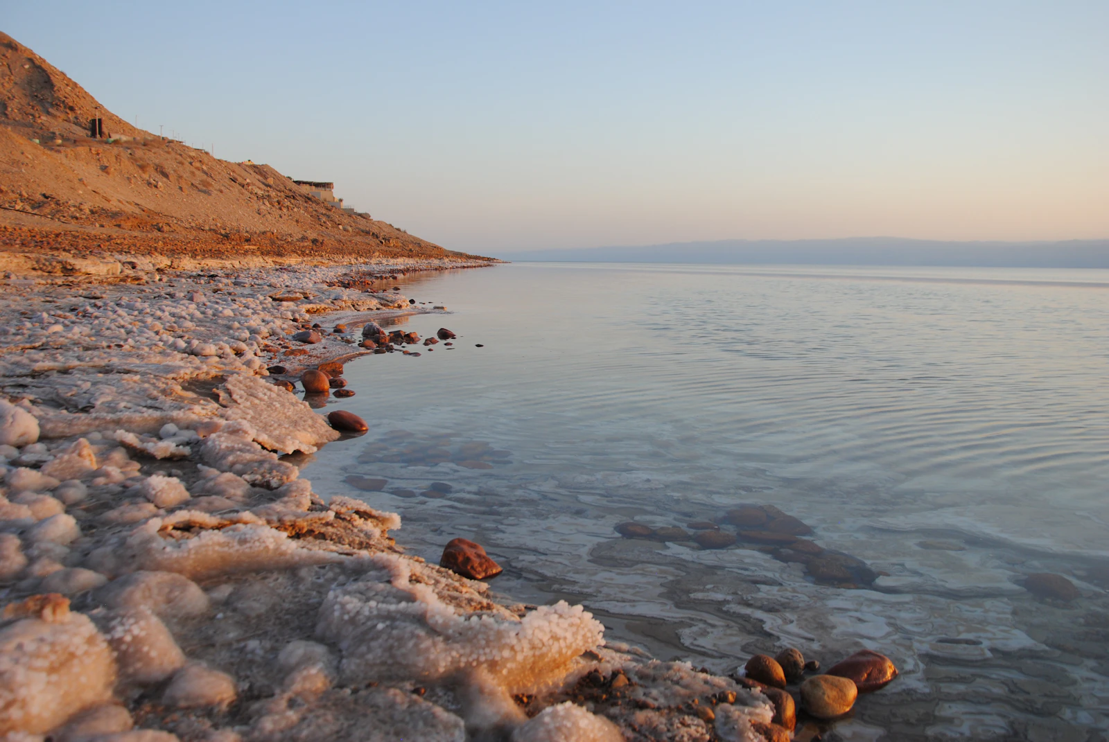 The sea’s shoreline is illuminated by the sun