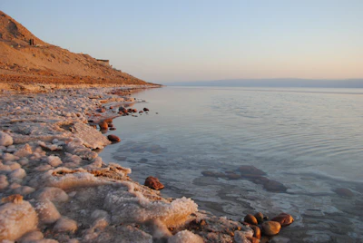 The sea’s shoreline is illuminated by the sun