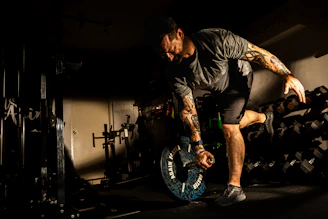 A man balances on one leg while working out