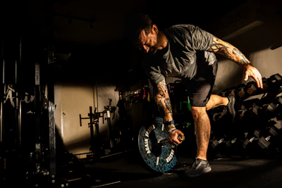 A man balances on one leg while working out