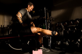 A man is exercising with a leg extension.