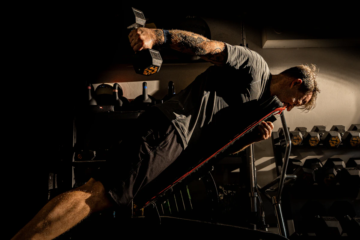 Man lifting weights at the gym, illustrating the cellular energy and NAD+ levels that support strength and recovery as men age.