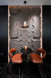 Cozy seating area with stone wall and ambient lighting