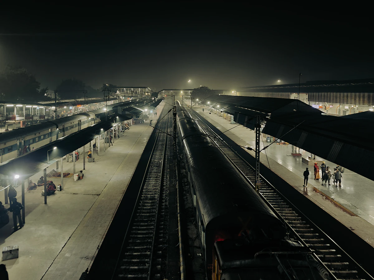 Passengers waiting on a British railway station platform as a train arrives