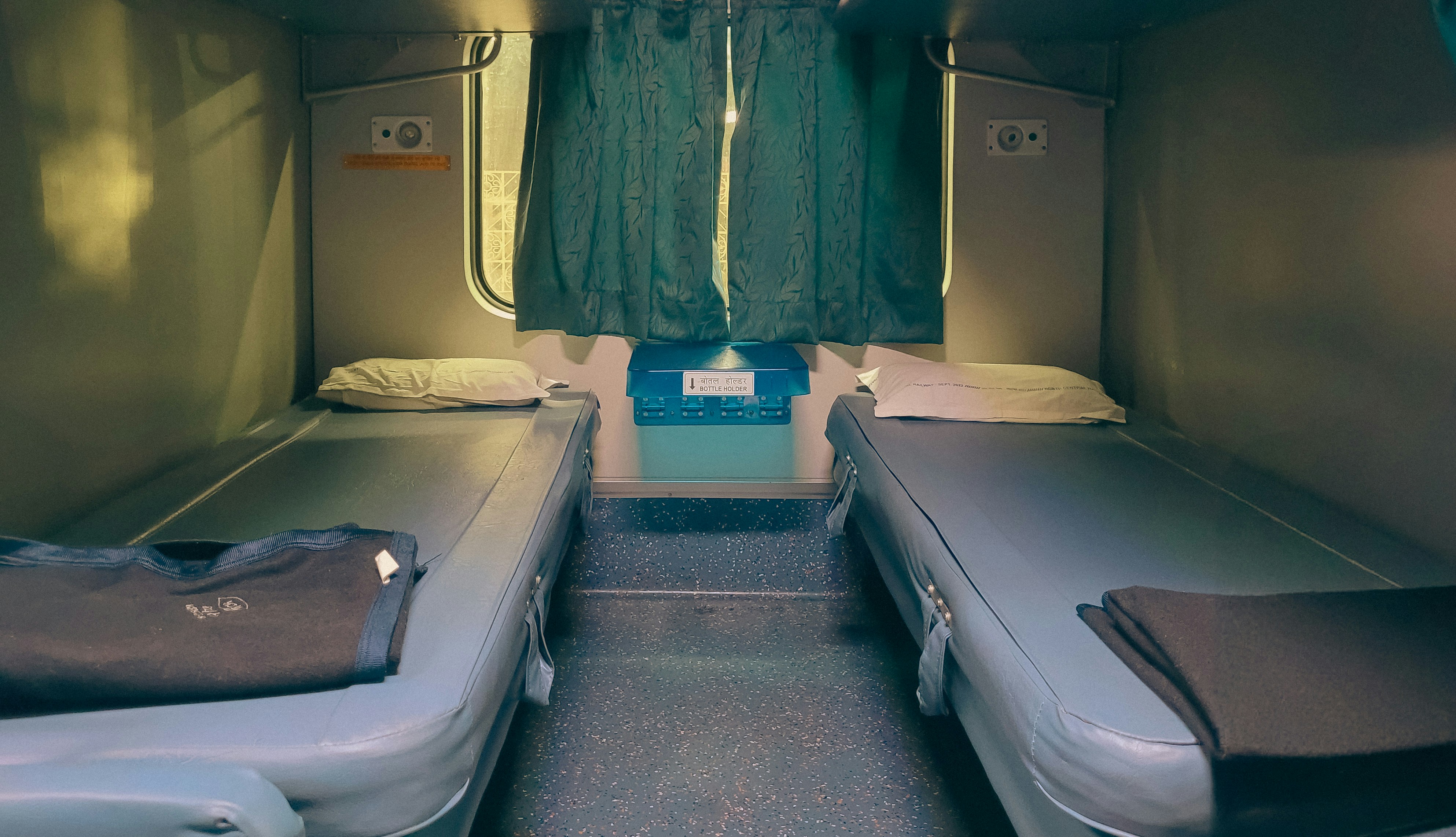 Two beds inside a train cabin.