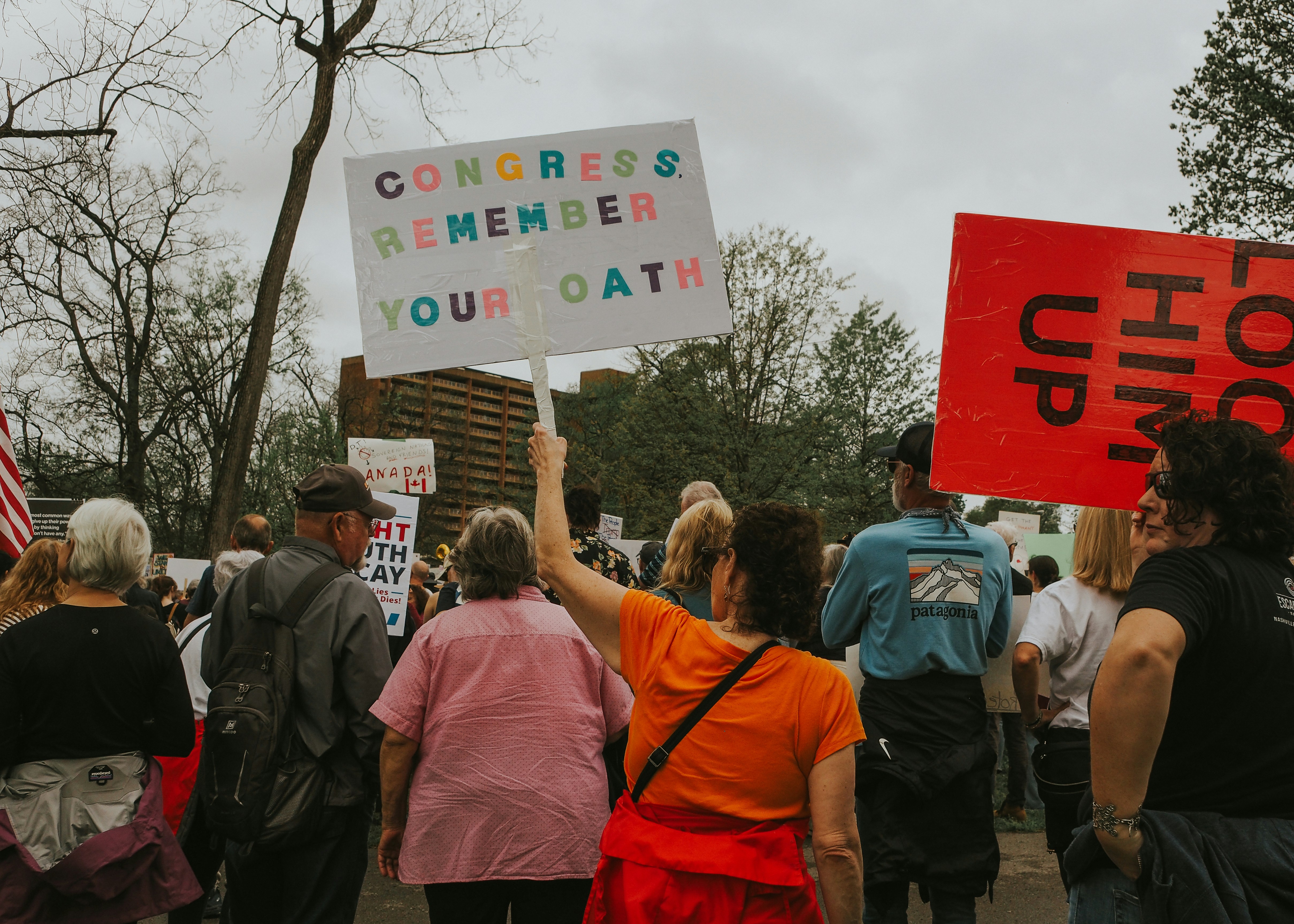 Protesters hold signs at a rally or demonstration. photo – Free Woman ...