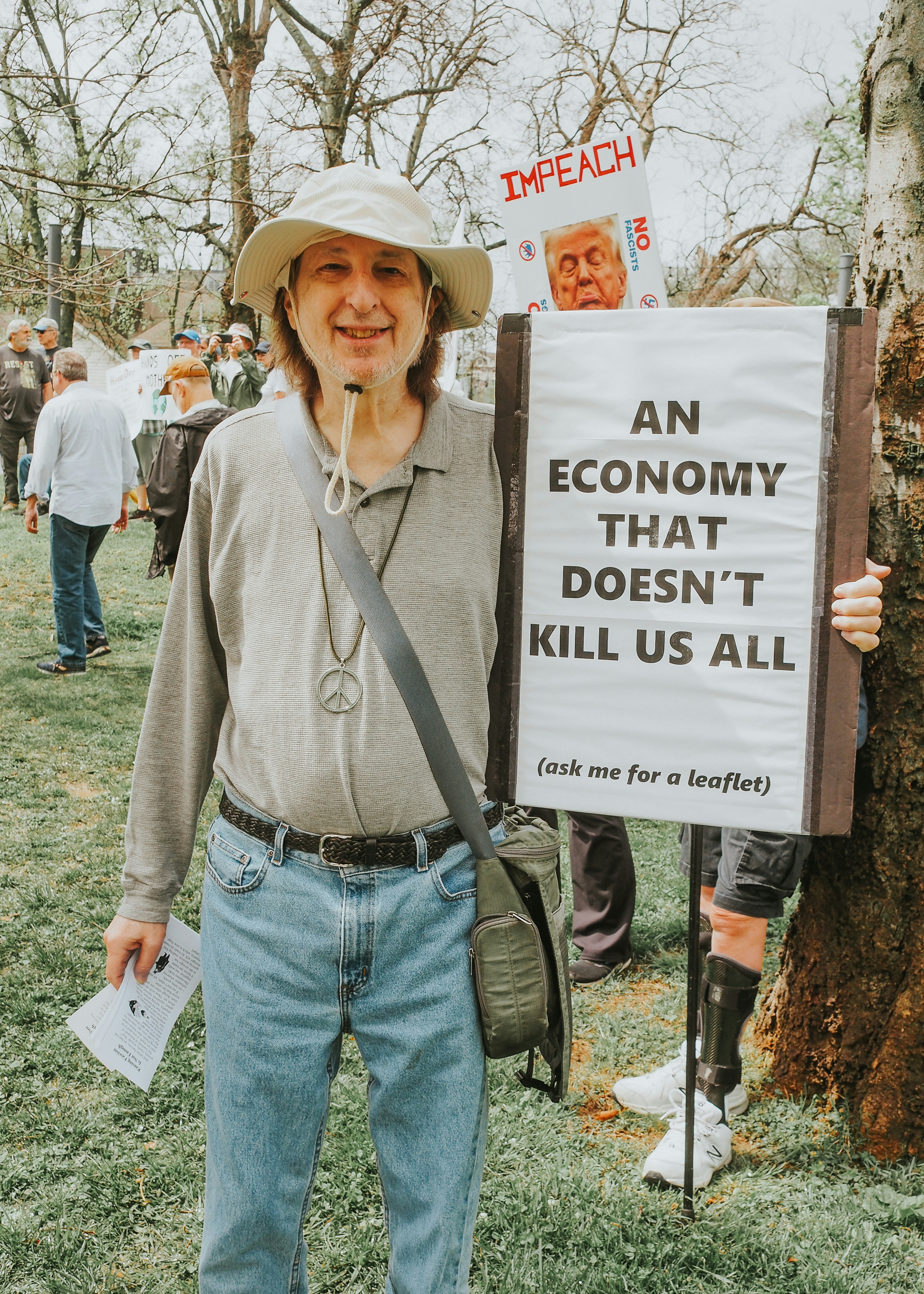 Protester holds sign calling for an end to harmful economy.