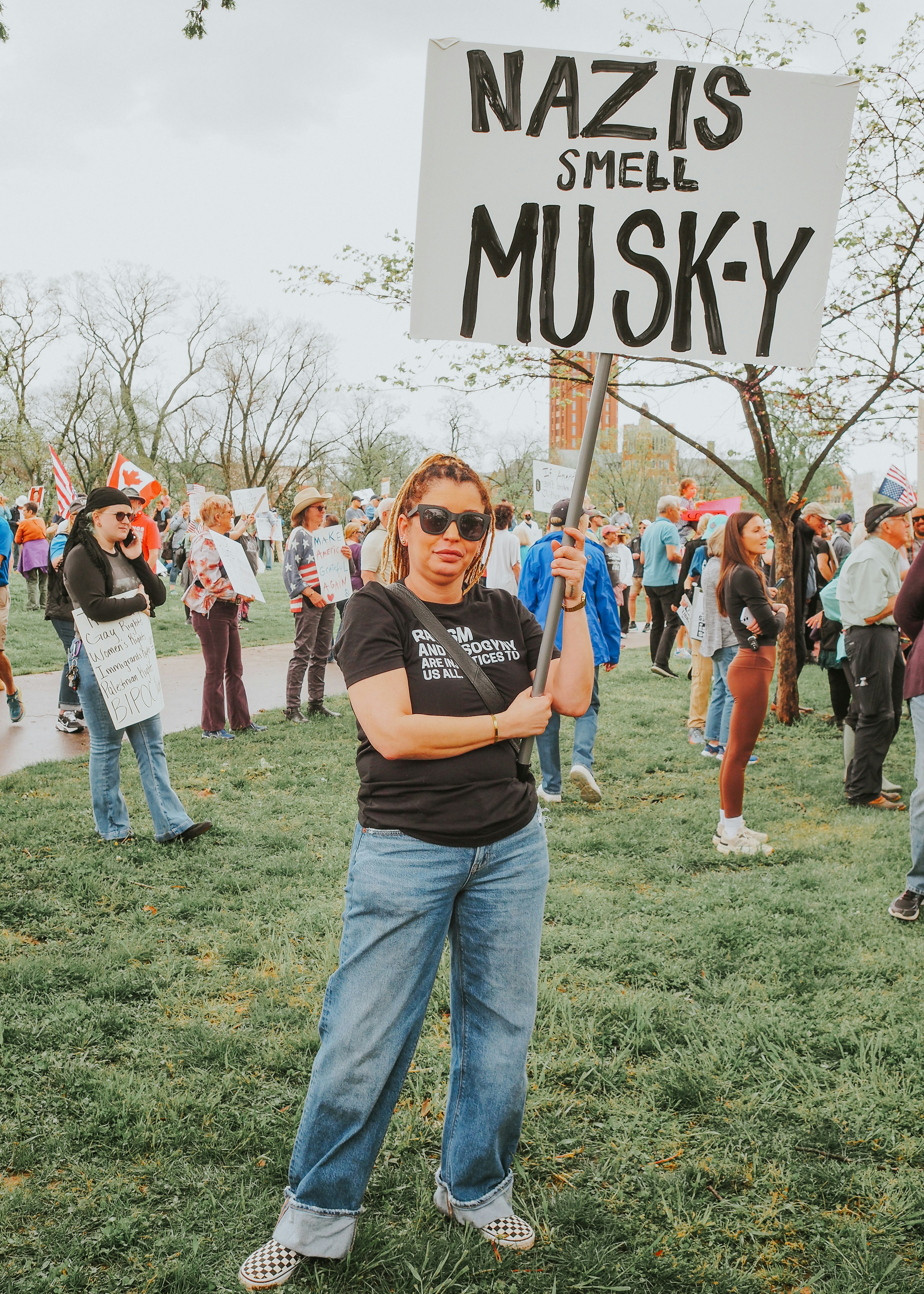 Woman holds a sign reading 
