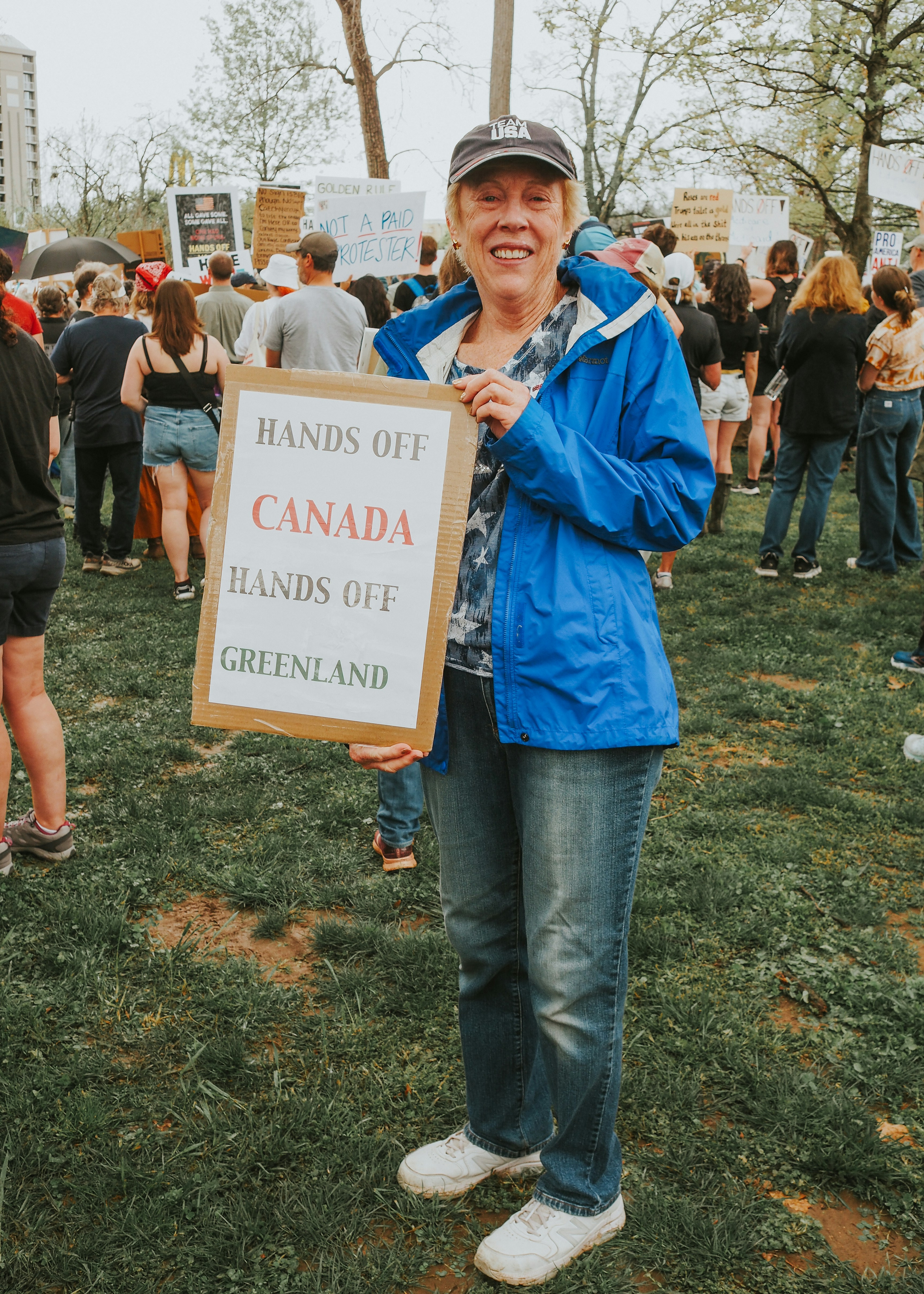 Woman protests with a sign at a rally.