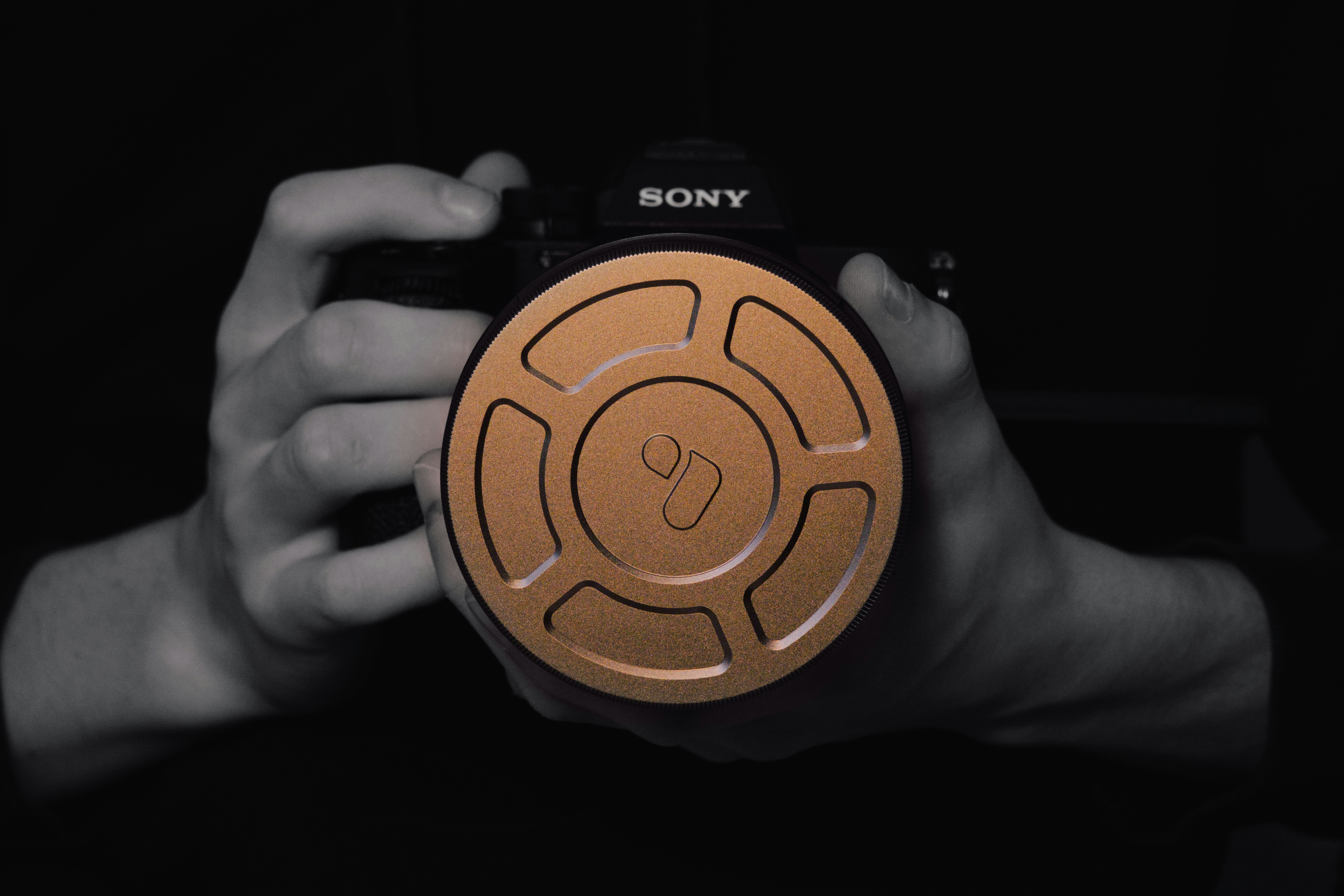 A camera is being held by hands.