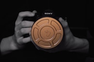 A camera is being held by hands.