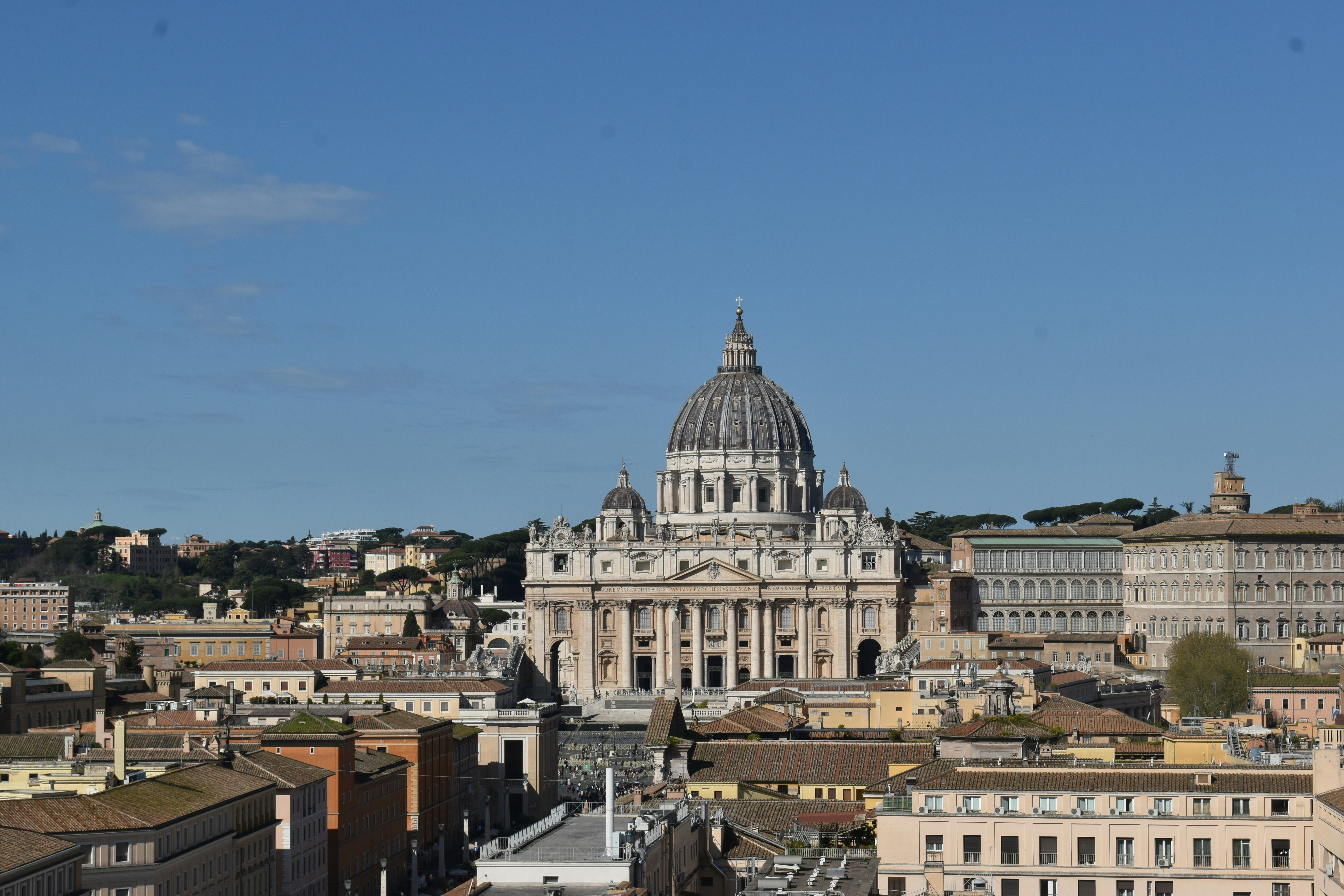 St. peter's basilica stands majestically against blue sky.
