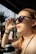 Woman shielding her eyes from the sun's glare.