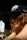 A woman with red hair wears a black hat.