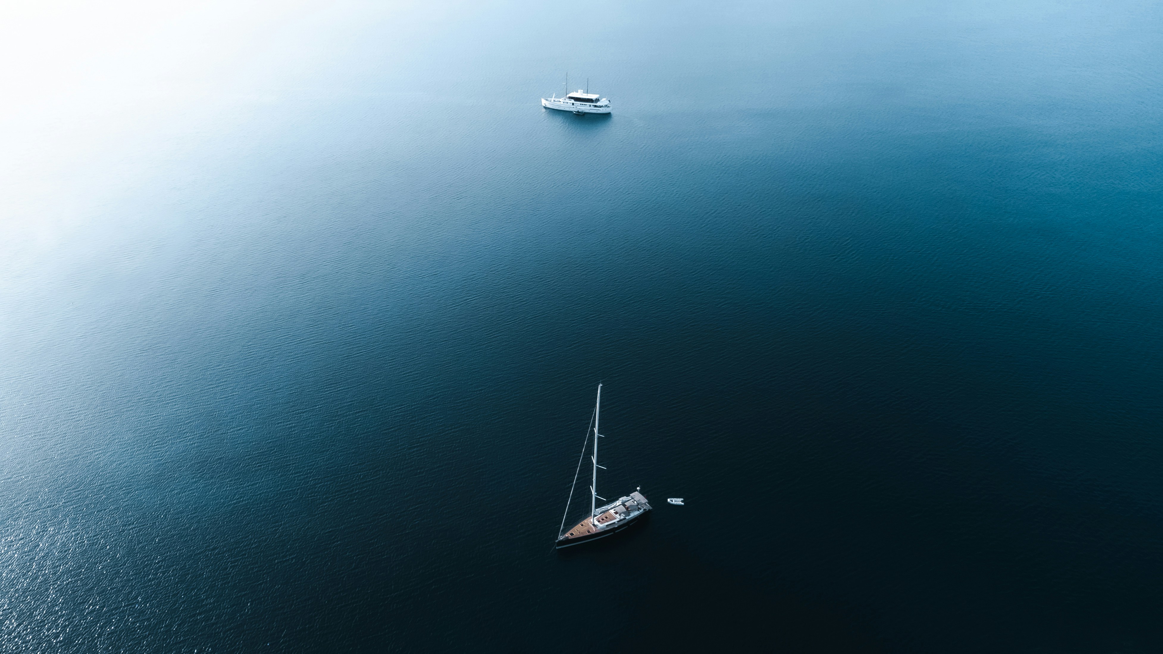 Boats float on a calm, blue body of water