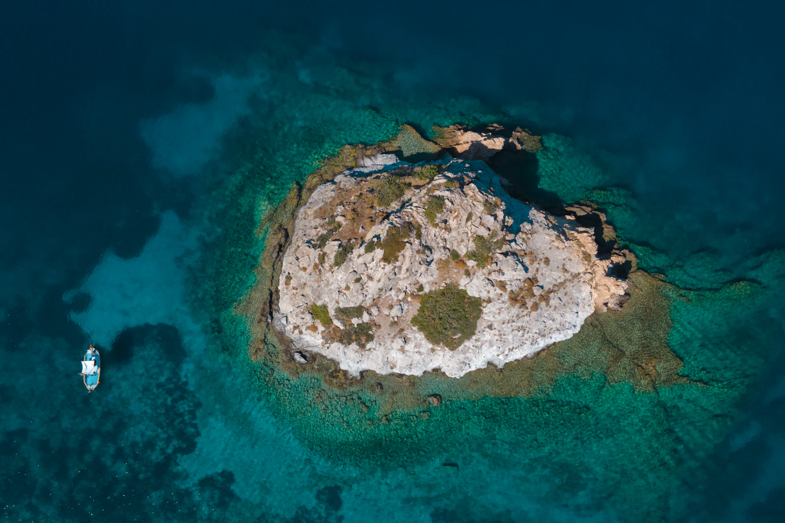 A small island resting in turquoise Greek waters