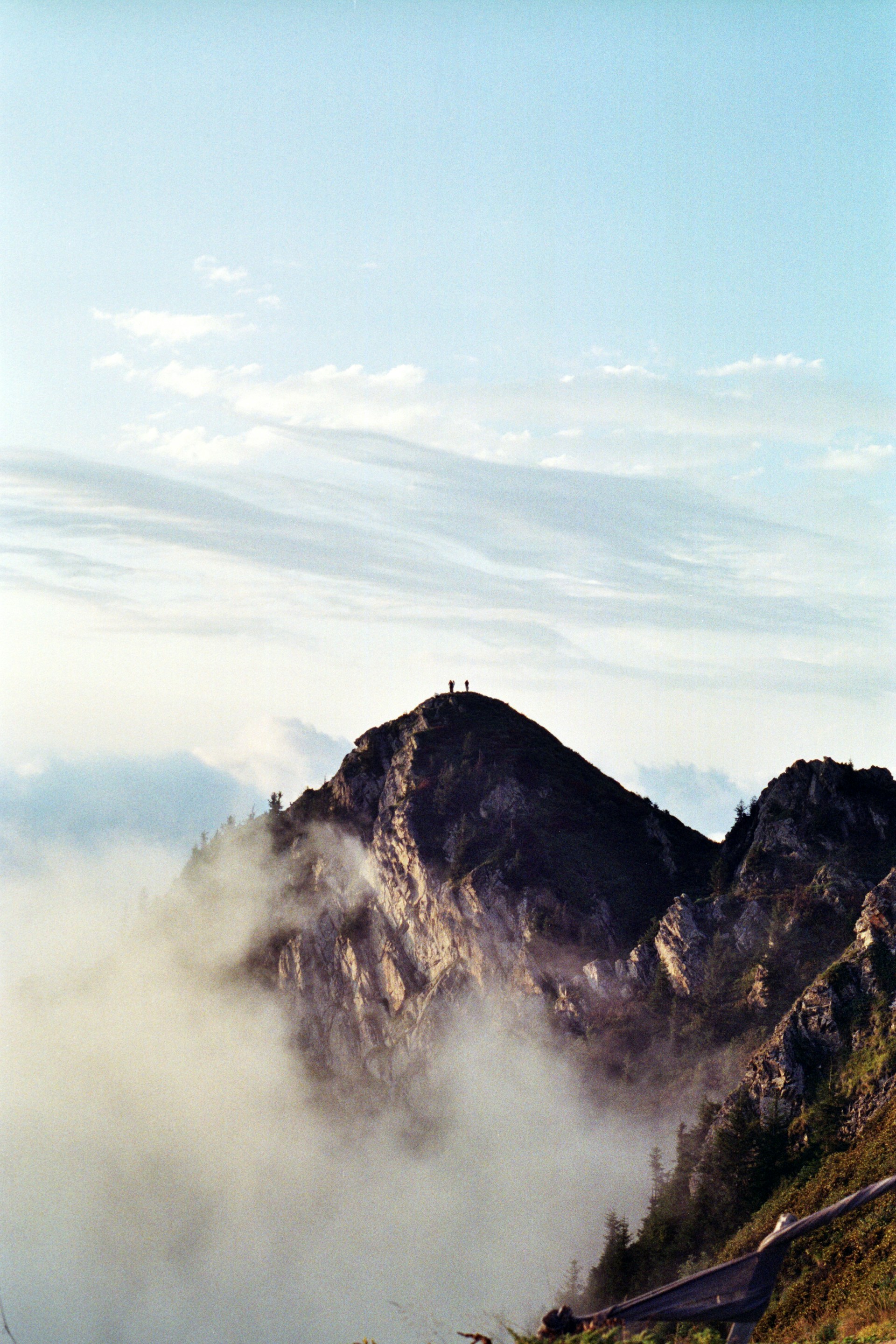 Mountain peak enveloped in morning mist.