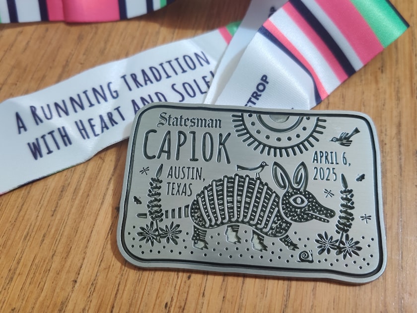 Race medal and ribbon from the cap10k austin.