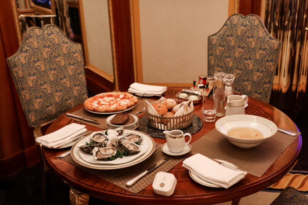 A round table is set with several courses of food., Amazing 24 hour room service