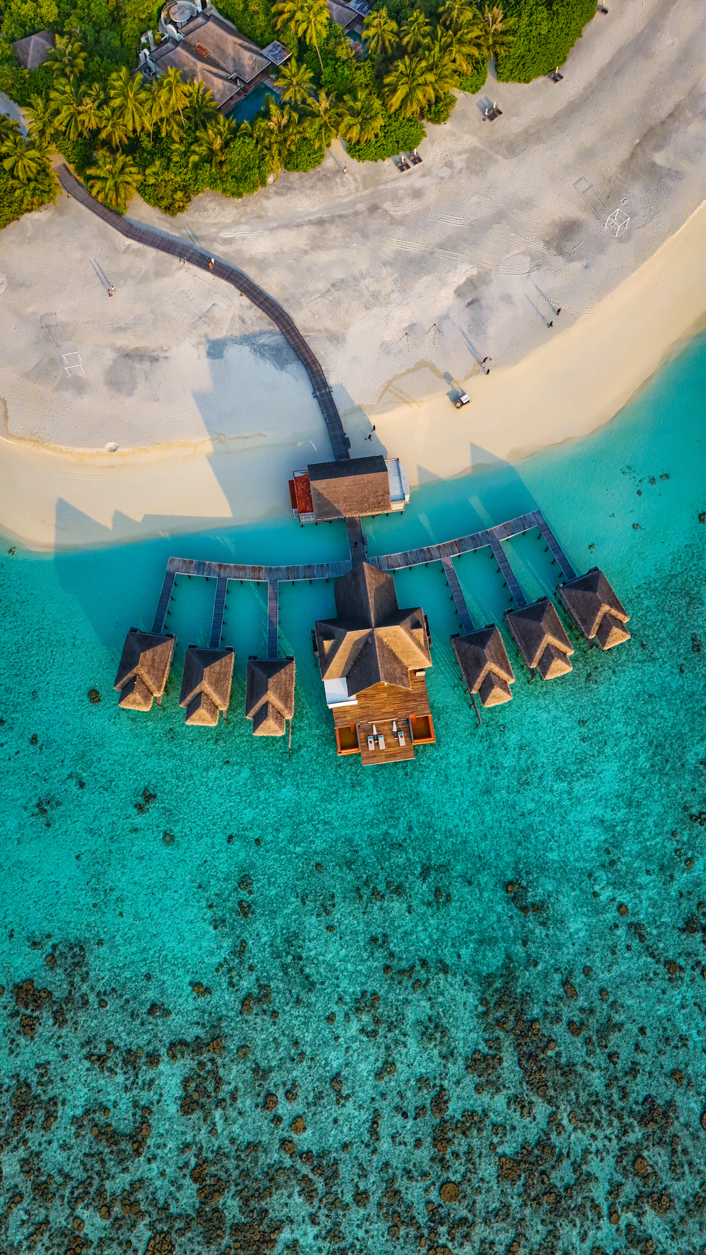 Overwater bungalows beside Kihavah Huravalhi island in the Maldives