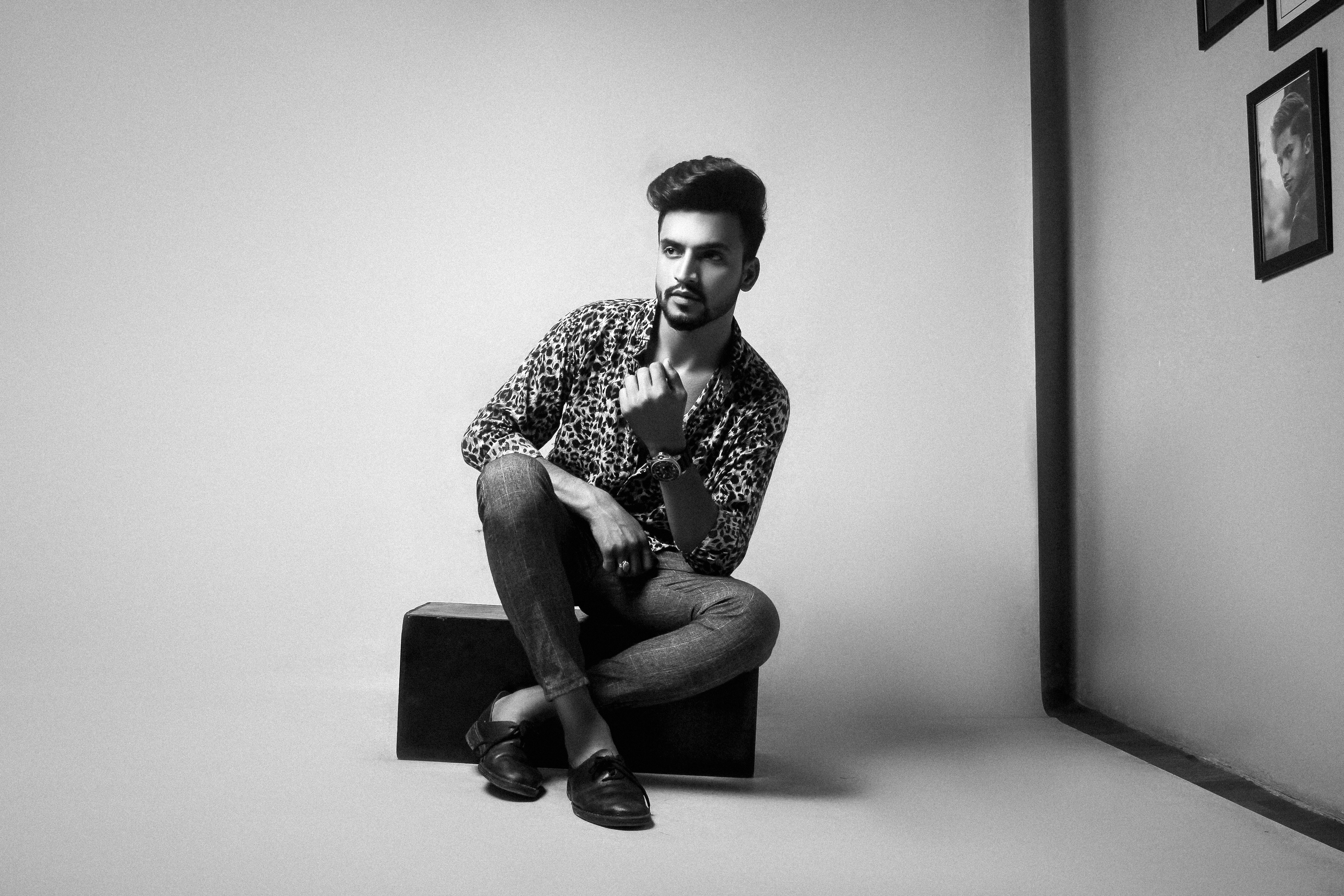 Stylish man poses for a photo in a studio.