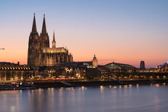 Cologne cathedral at dusk, reflected in the water.
