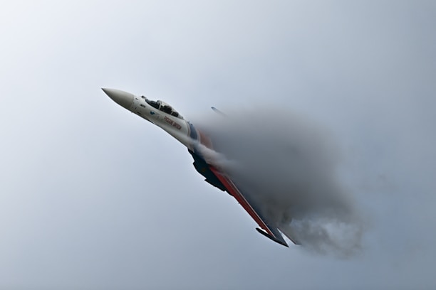 A fighter jet creates a vapor cone.
