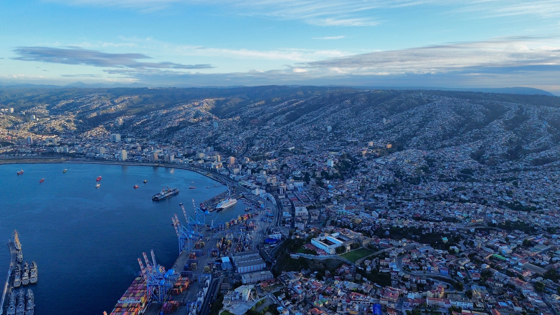 A scenic coastal city sprawls beside the ocean.