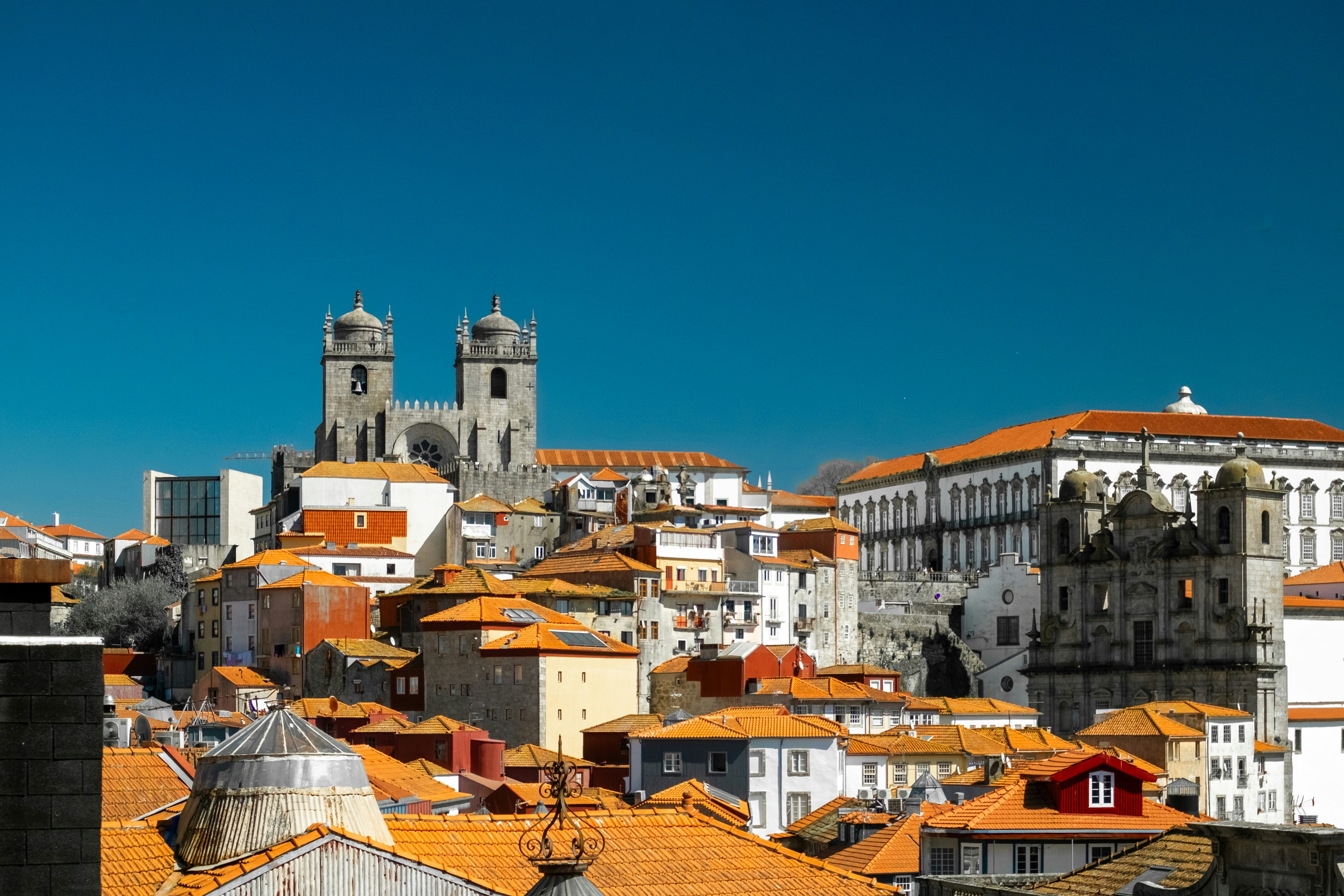Cityscape of porto, portugal, under a clear blue sky.by Noelephants Flying