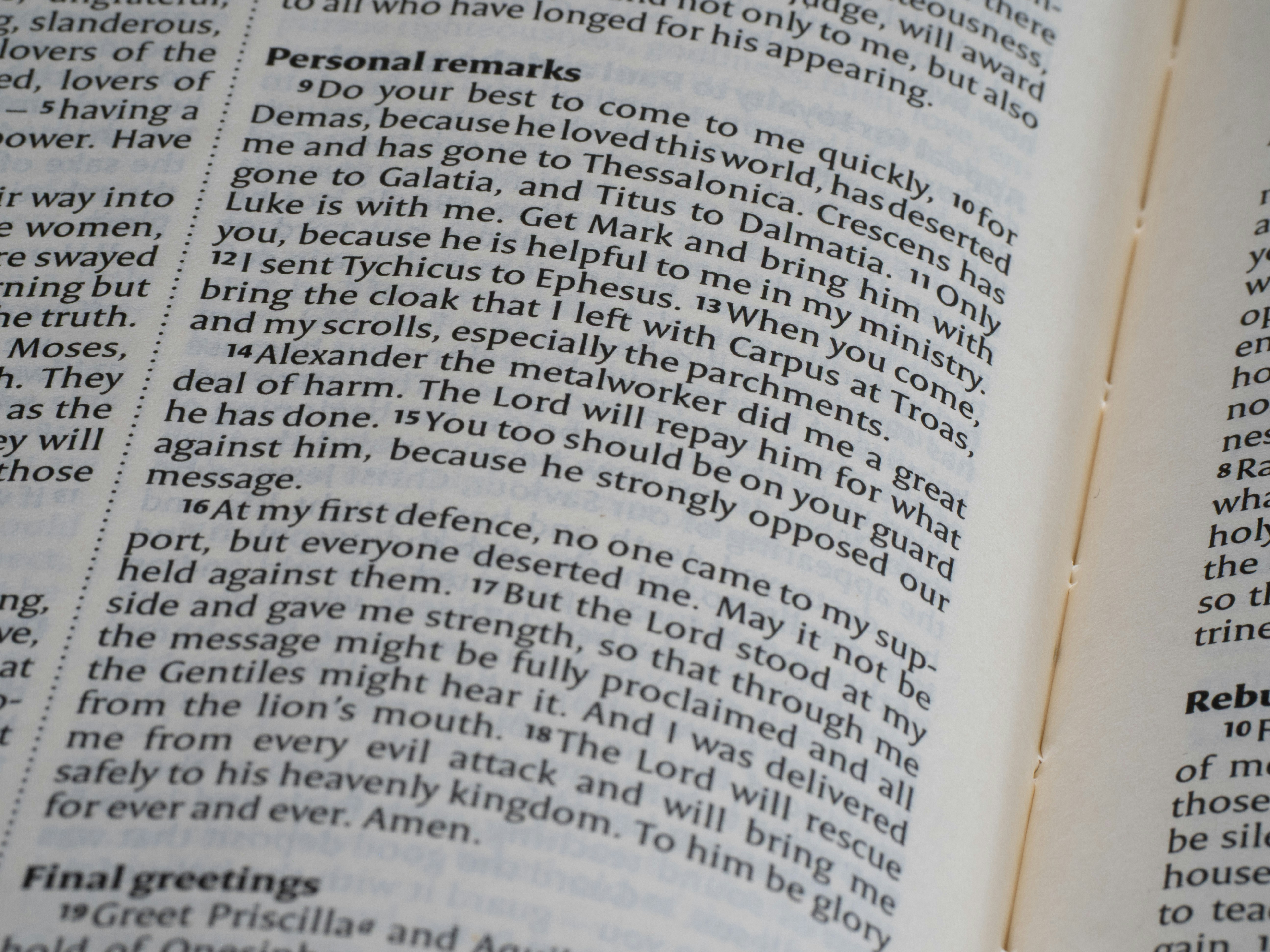 The image shows an open bible with text.