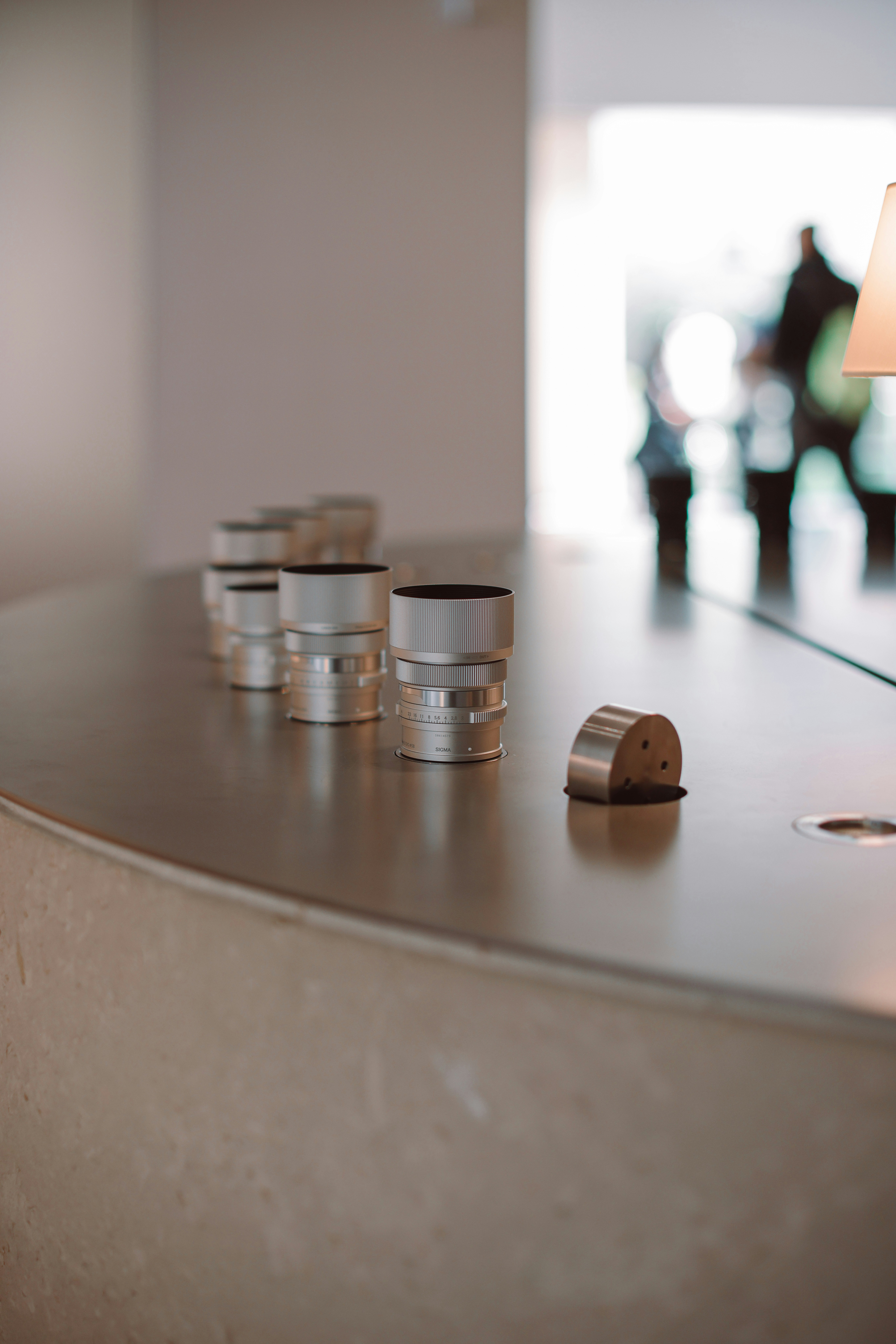 Metal objects sit on a curved countertop.