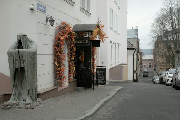A street in the old town with a cloaked statue — Vyborg, Russia
