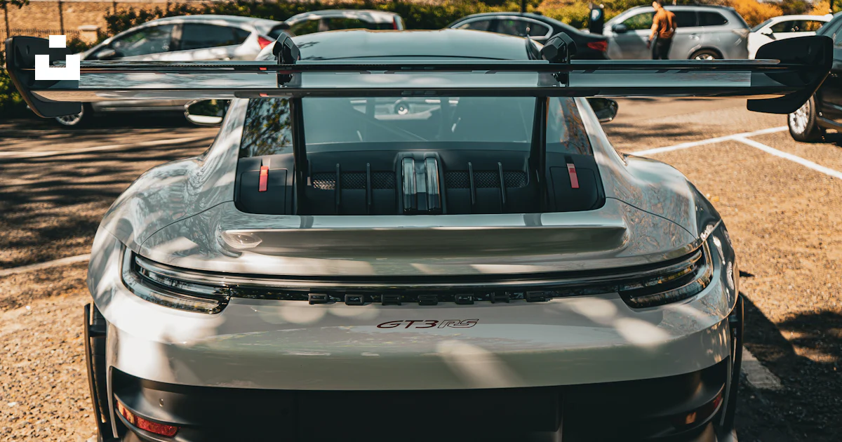 Here is a caption: a porsche gt3 with a large rear wing. photo – Free ...