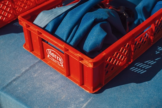 Red crate containing blue cloth.