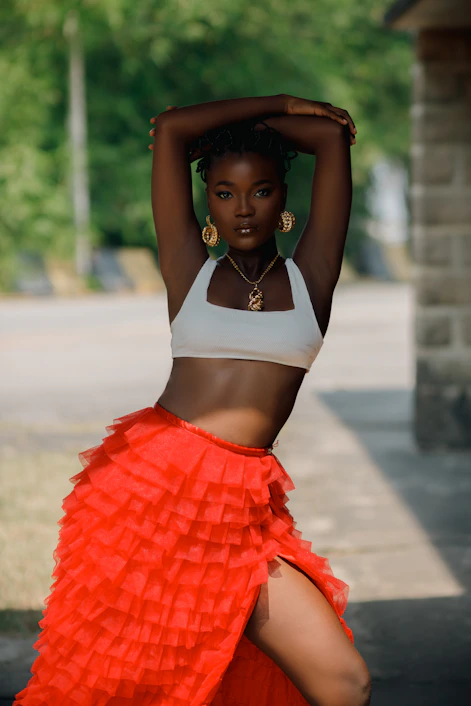 Beautiful woman poses outdoors in stylish attire.