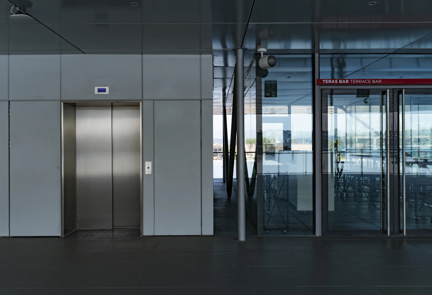 Glass doors and an elevator in a building; illustrative photo