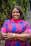 Woman smiles warmly while crossing her arms.