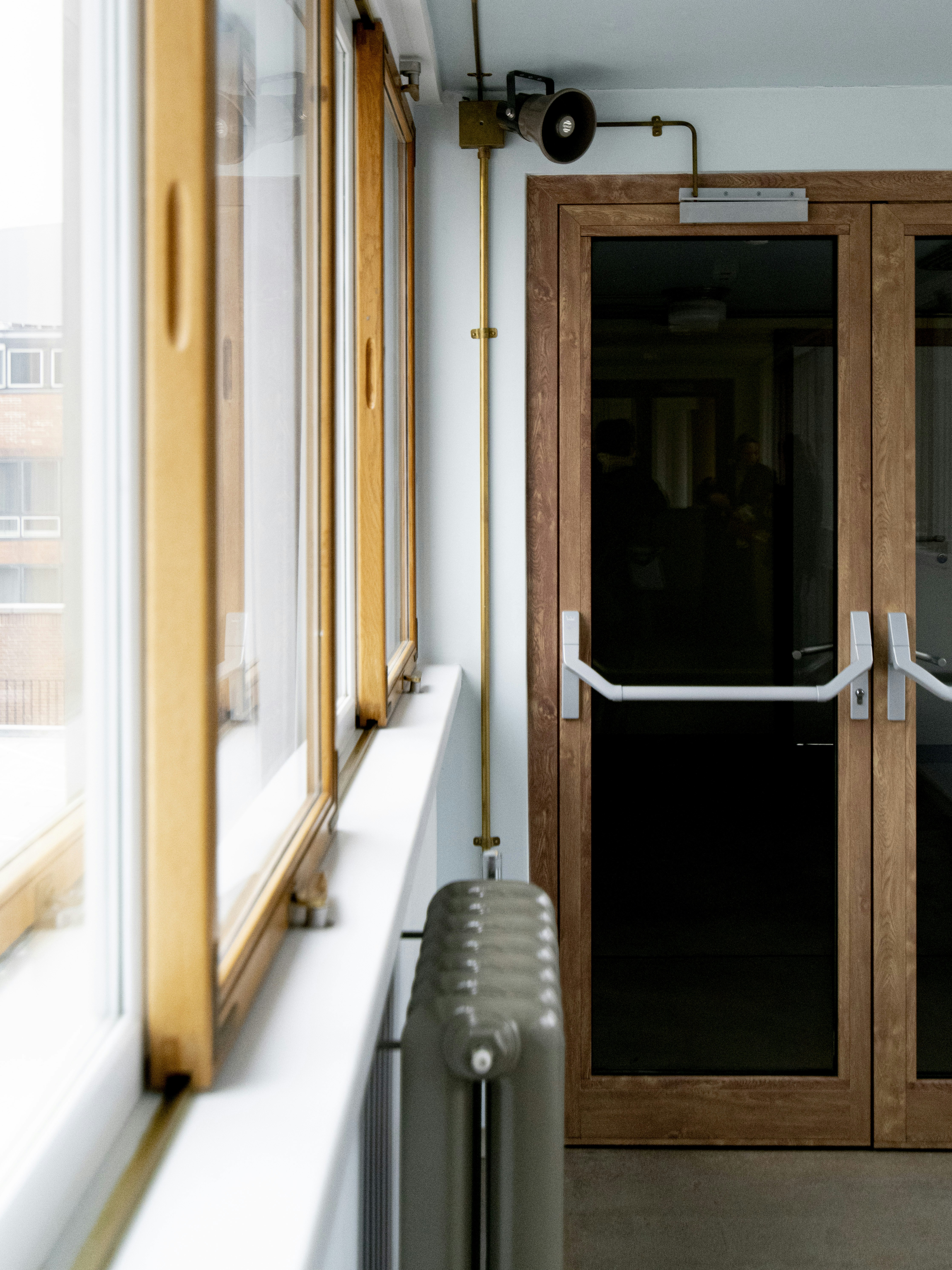 Residential interior with radiator, windows and door