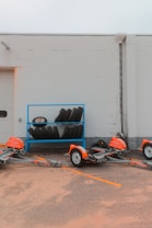 Tires sit next to trailers in front of a building.