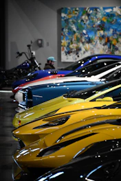 Beautiful sports cars lined up in a showroom.