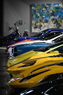 Beautiful sports cars lined up in a showroom.