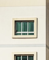 Windows on a white building in daylight.