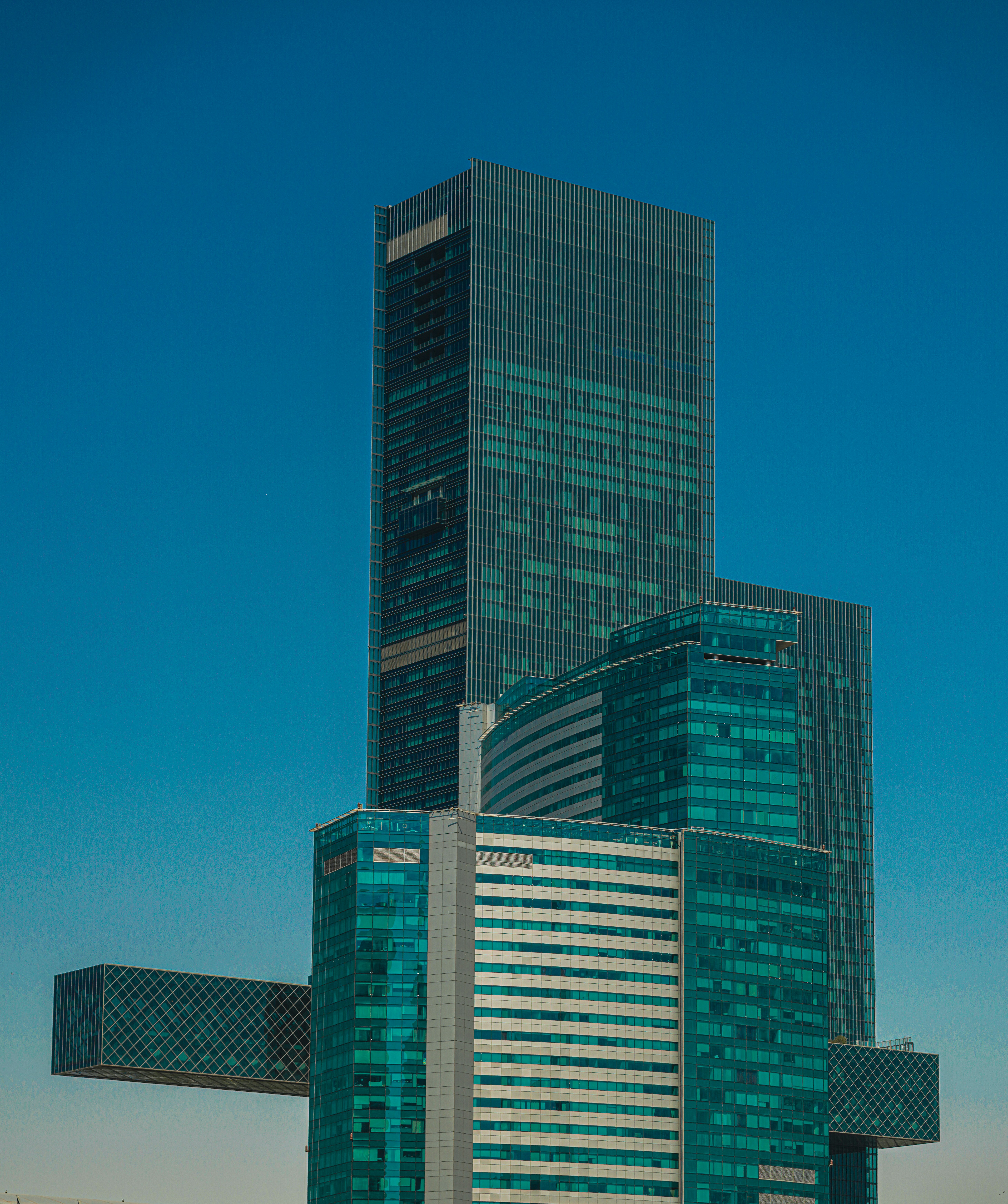 Skyscrapers rise against a vibrant blue sky.