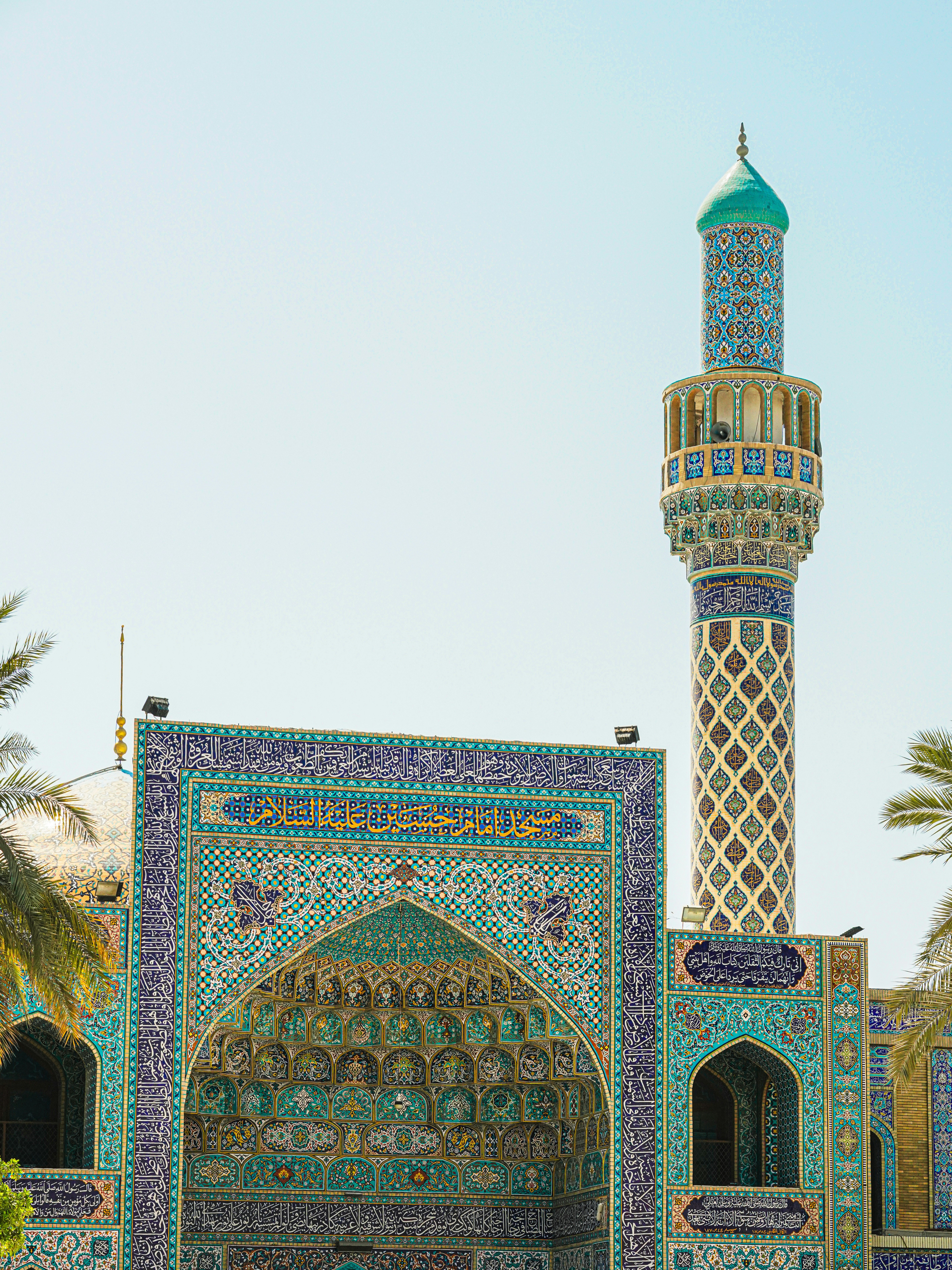 A beautiful mosque and minaret under a clear sky.