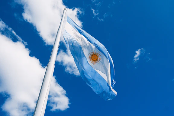 The argentinian flag flies proudly in the sky.