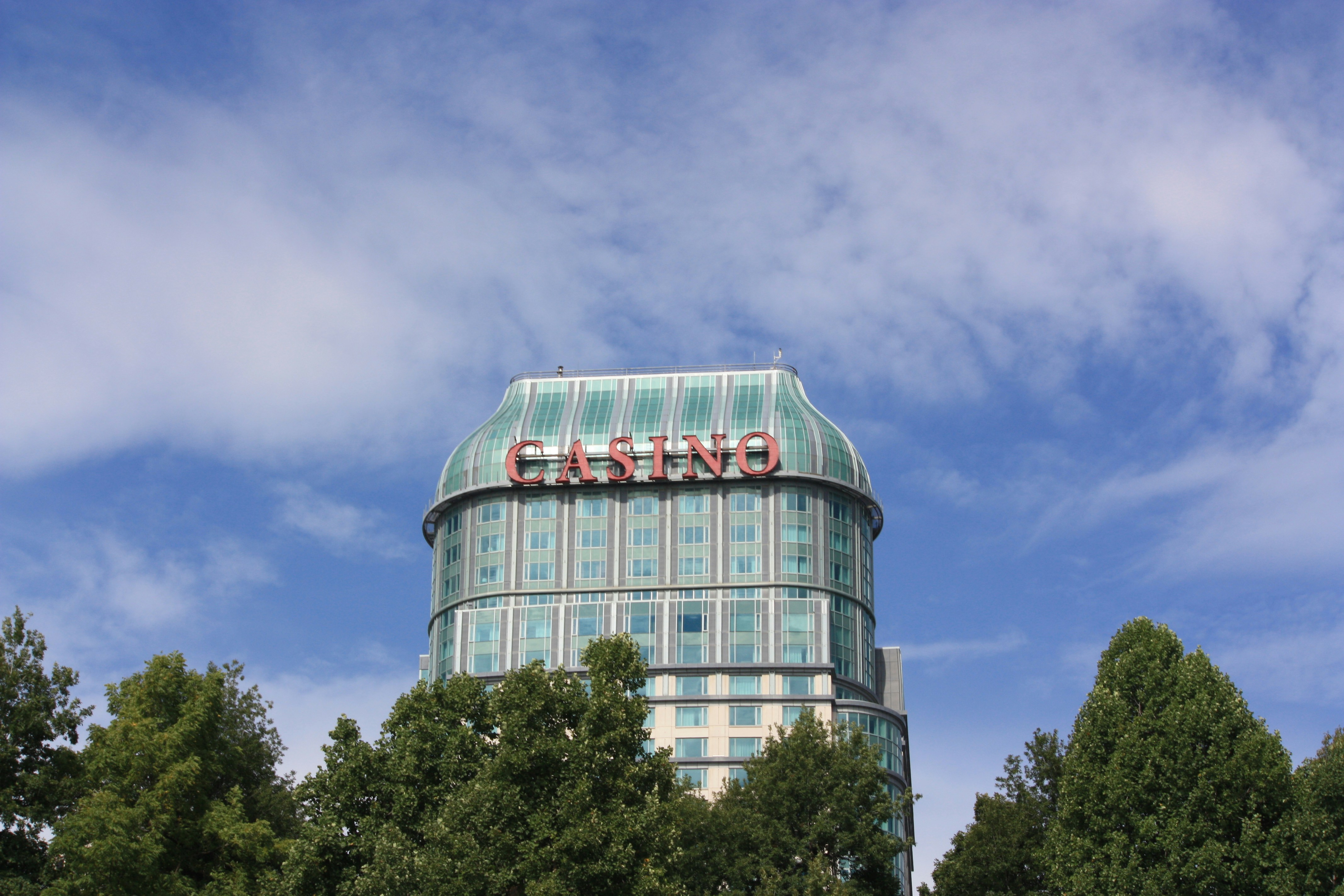 A casino building stands tall under a blue sky.