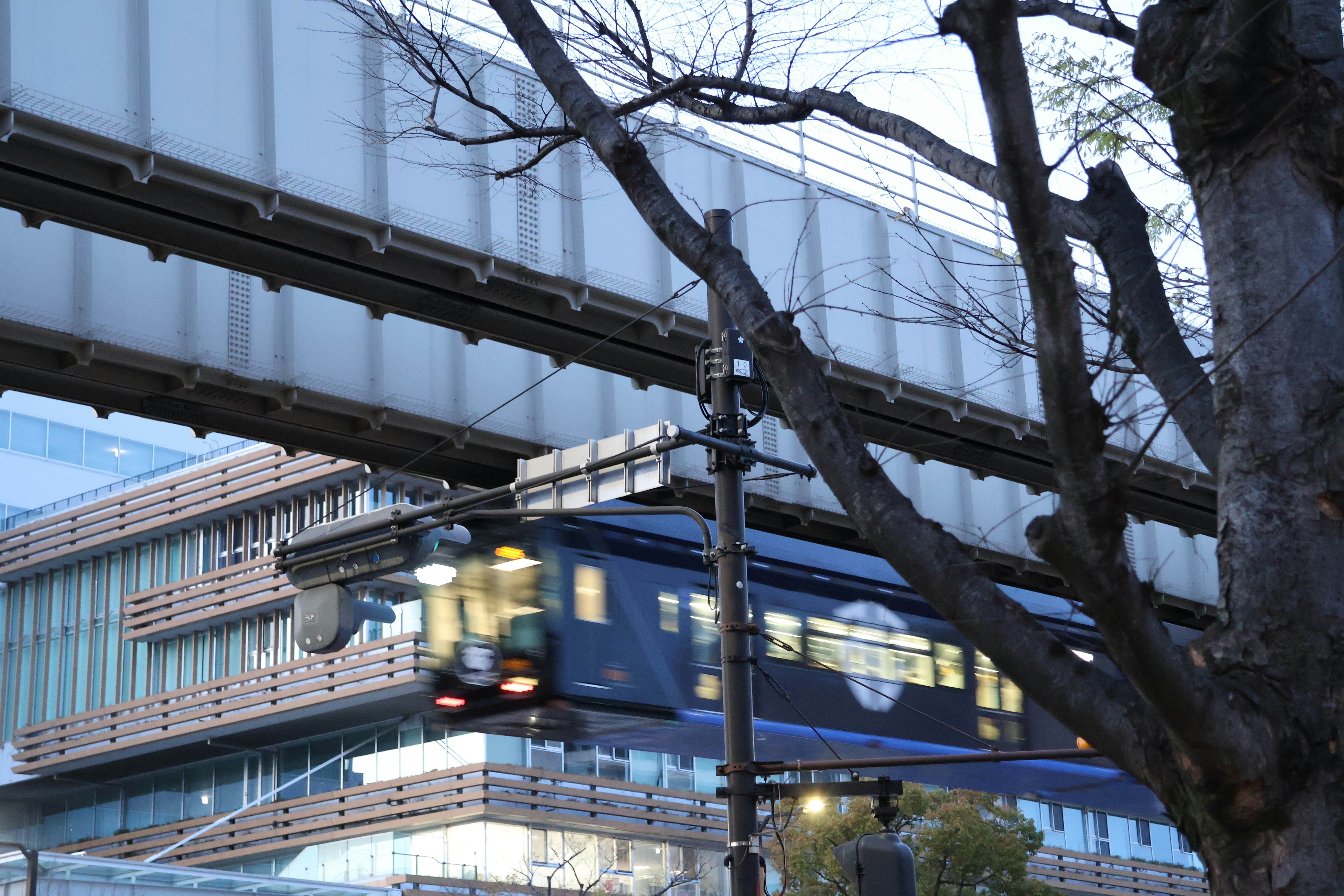 A train passes under an overpass.