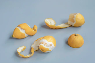 Lemon pieces and peels are arranged on a surface.