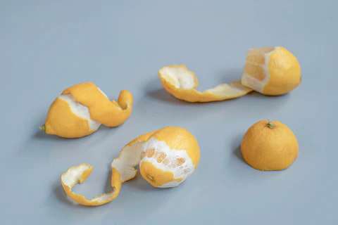 Lemon pieces and peels are arranged on a surface.