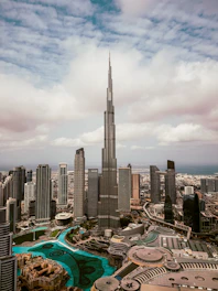 The burj khalifa stands tall amidst a city skyline.